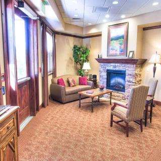 A cozy lobby area featuring a fireplace and comfortable seating.