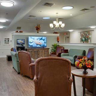 A cozy living room with comfortable seating and a large television.