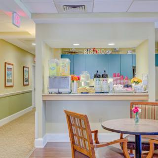 A cozy cafe interior with a seating area and a view of the service counter.