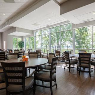 A spacious and modern dining area with large windows providing plenty of natural light.