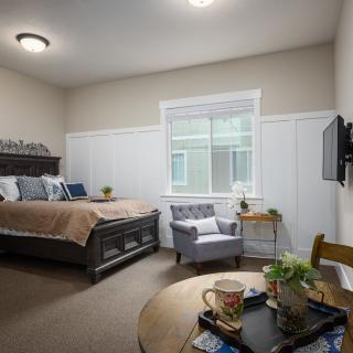A modern and cozy bedroom with stylish decor and comfortable furnishings.