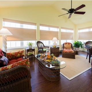 A bright living room with comfortable seating, abundant natural light, and tasteful decor.