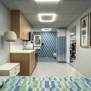 A modern hospital patient room featuring contemporary design elements and a clean aesthetic.