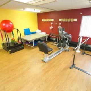 A physical therapy room with various exercise equipment for rehabilitation.