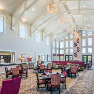 Spacious dining area with elegant decor and large windows.