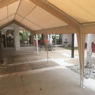 A spacious covered outdoor area with a tent providing shade.