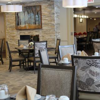 A modern dining room with neatly arranged tables and chairs, featuring stylish decor.