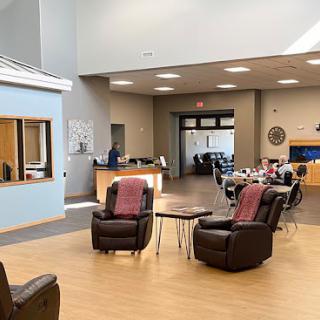 A spacious lobby area with comfortable seating and a reception desk.