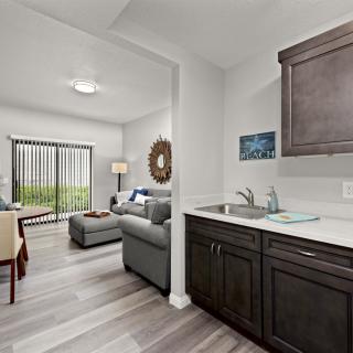 A modern apartment featuring an open living room and kitchenette with contemporary furnishings and decor.