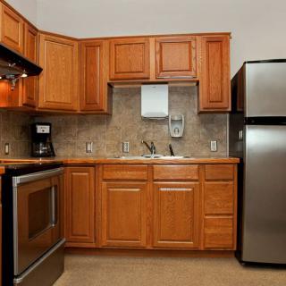 A modern kitchen with wooden cabinets and stainless steel appliances.