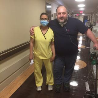 A moment of connection between a nurse and a patient in the hospital hallway.