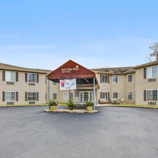 The exterior view of a hotel building with a drive-up entrance and surrounding parking area.