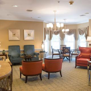 A cozy lounge area with elegant furniture and warm lighting.