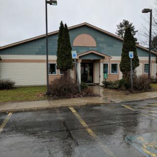 A modern building with a decorative facade on a rainy day.