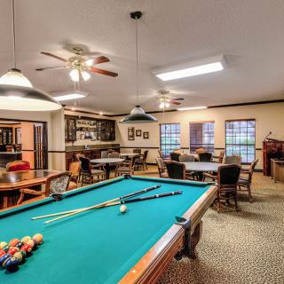 A cozy game room featuring a pool table and seating area.