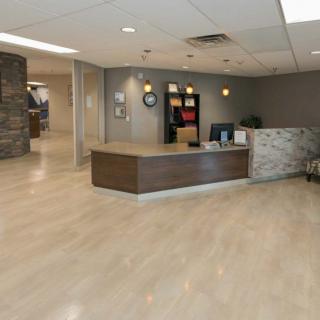 A modern office reception area with a front desk and stylish decor.