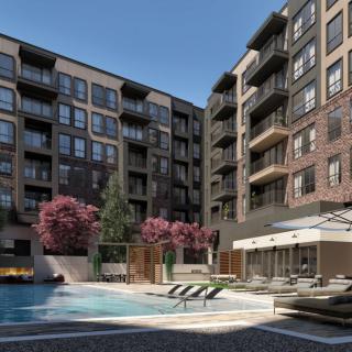A modern apartment complex with a swimming pool and landscaped outdoor area.