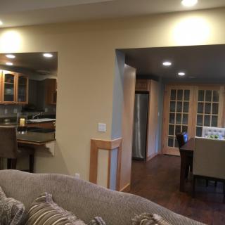 Open concept living area with a view into the kitchen and dining space.