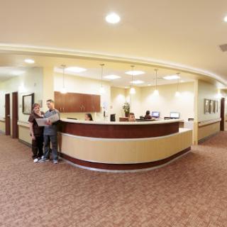 A welcoming reception area with staff and visitors.