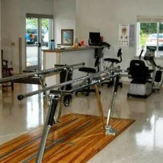 A physical therapy clinic with rehabilitation equipment.