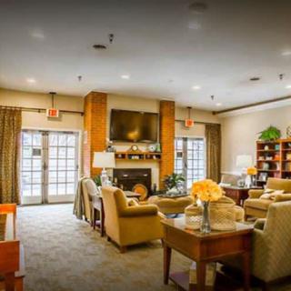 A cozy living room featuring comfortable seating, a fireplace, and a television.