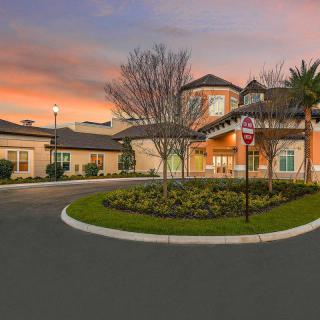 A picturesque residential building at sunset with well-maintained landscaping.