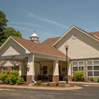 A view of a residential building with a landscaped entrance.