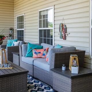 Cozy outdoor patio space with comfortable seating and colorful decor.