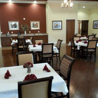 An elegant dining room with neatly arranged tables and chairs, featuring tasteful decor.