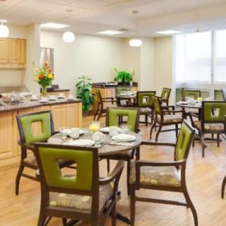 A well-lit dining area featuring tables and chairs with modern decor.