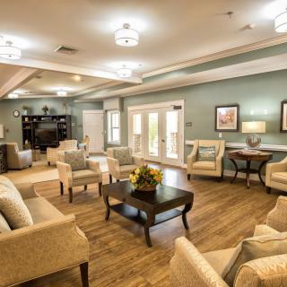 A cozy and modern lounge area with comfortable seating and warm lighting.