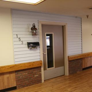 A well-designed interior space featuring a door, wooden accents, and decorative wall elements.
