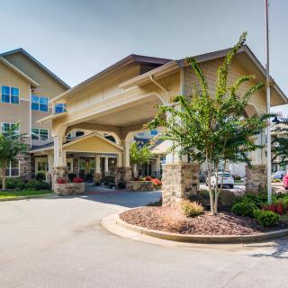 A well-maintained building entrance surrounded by landscaping.