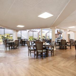 A spacious and modern dining area with neatly arranged tables and chairs.