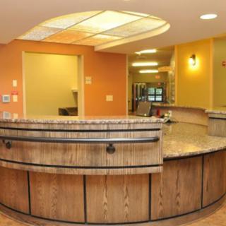 A cozy reception area with a curved counter and warm lighting.