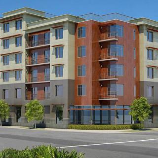 A modern apartment building with a mix of materials and urban design.