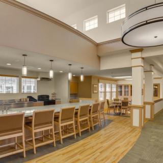 A spacious and modern dining area with a long counter and seating.