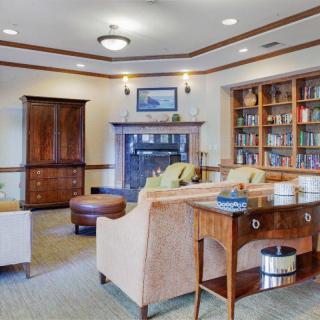 Cozy living room with sofas, a bookshelf, and a fireplace.