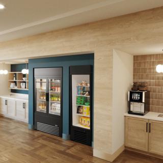 A modern snack and beverage area featuring vending machines, beverage refrigerators, and a coffee station.