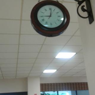 A classic wall clock displaying the time in a well-lit interior space.