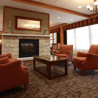 A cozy living room with a fireplace and comfortable seating.