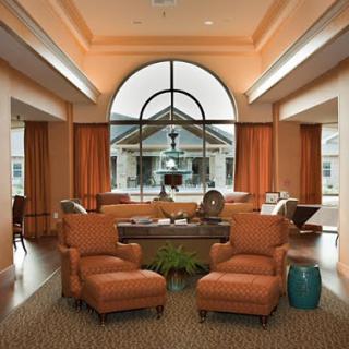 A cozy and well-lit lobby seating area featuring comfortable chairs and a welcoming atmosphere.