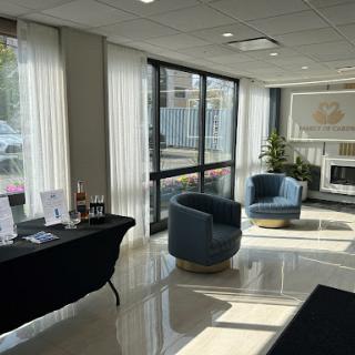 A modern lobby area featuring stylish chairs and ample natural light.