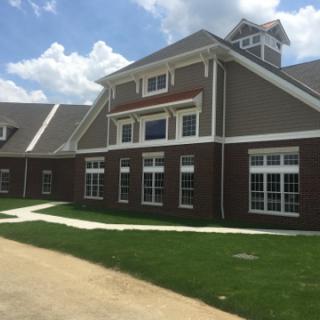A modern residential building with a well-maintained landscape.