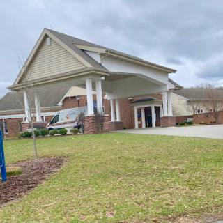 A residential building with a welcoming entrance on a cloudy day.