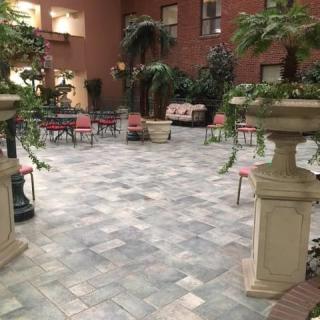 An indoor courtyard featuring potted plants and a seating area.