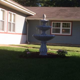 A beautiful fountain situated in a well-maintained yard.