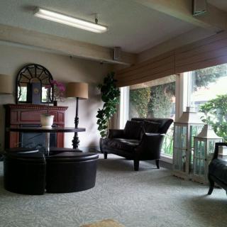 A cozy living room with elegant furniture and a large window, creating a welcoming ambiance.