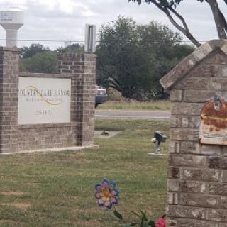 The entrance sign of a neighborhood, showcasing well-maintained landscaping and a decorative touch.