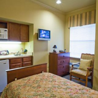 Cozy bedroom with a kitchenette and modern amenities.